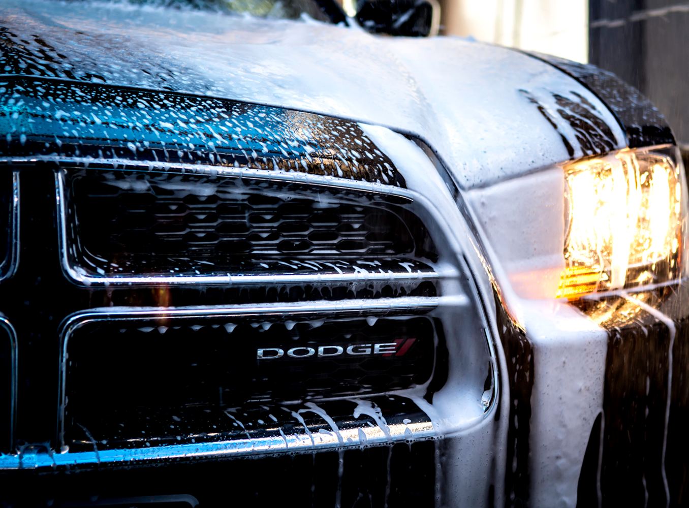 Truck grille covered in wash foam